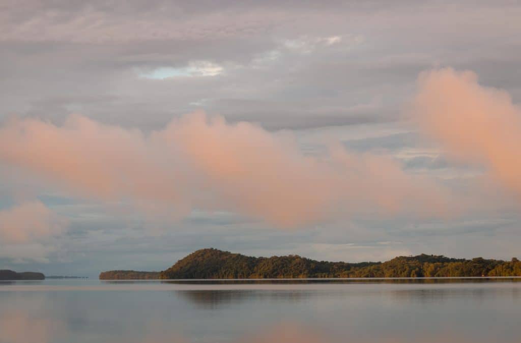 Pink clouds at dawn over an island in the Gulf of Montijo