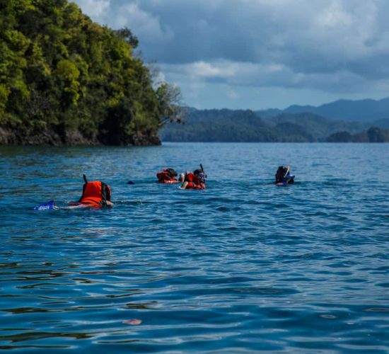A family along on a snorkeling spot in Coiba National Park