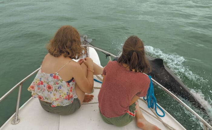 Dos mujeres observando delfines desde un bote en Panamá.